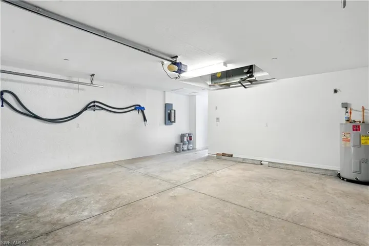 Spacious garage featuring concrete flooring and textured white walls