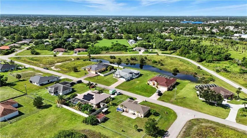 Aerial view of a residential neighborhood featuring single-story homes with various roof styles