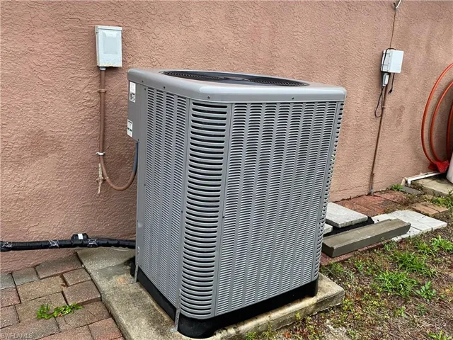 Details featuring central AC unit and stucco siding