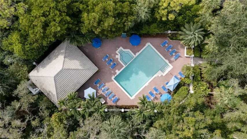 Bird's eye view of a pool and a tree filled landscape