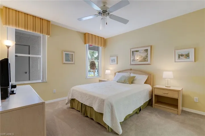 Bedroom featuring light colored carpet and ceiling fan