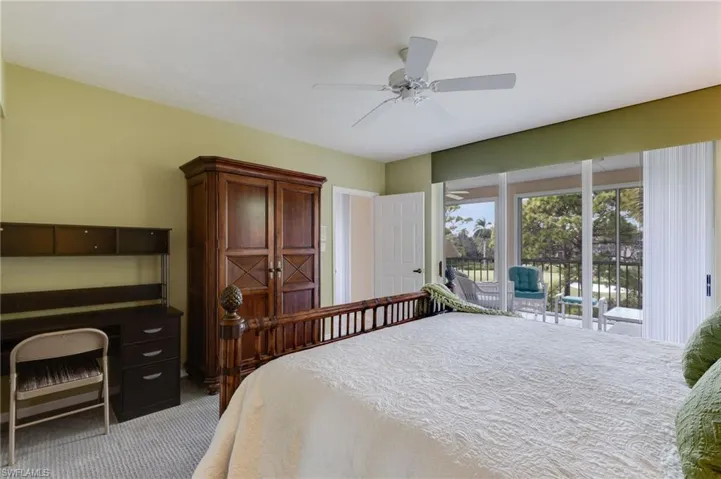 Carpeted bedroom with access to exterior and ceiling fan