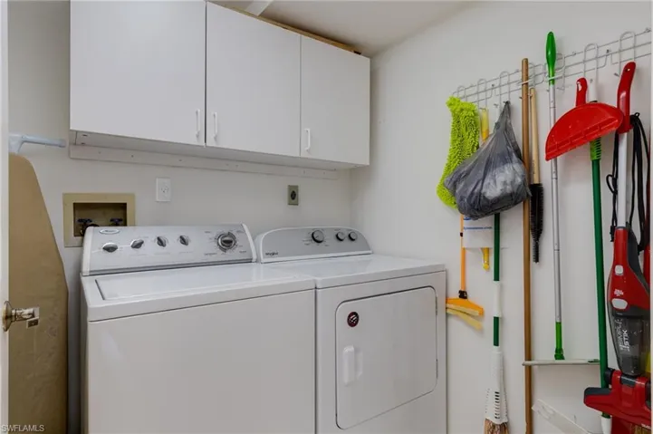 Laundry area with cabinet space and washing machine and dryer
