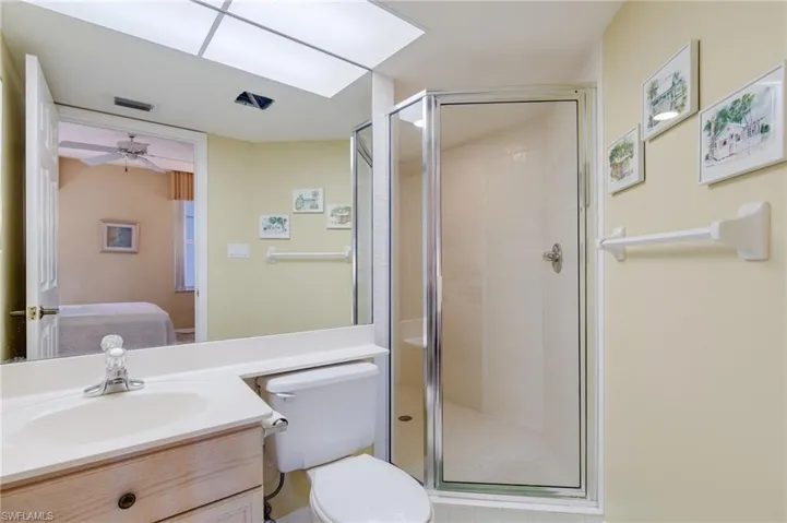 Bathroom with a stall shower, vanity, ensuite bathroom, and a ceiling fan