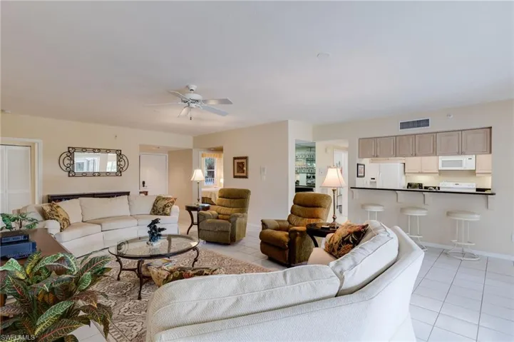 Living area with light tile patterned floors and ceiling fan