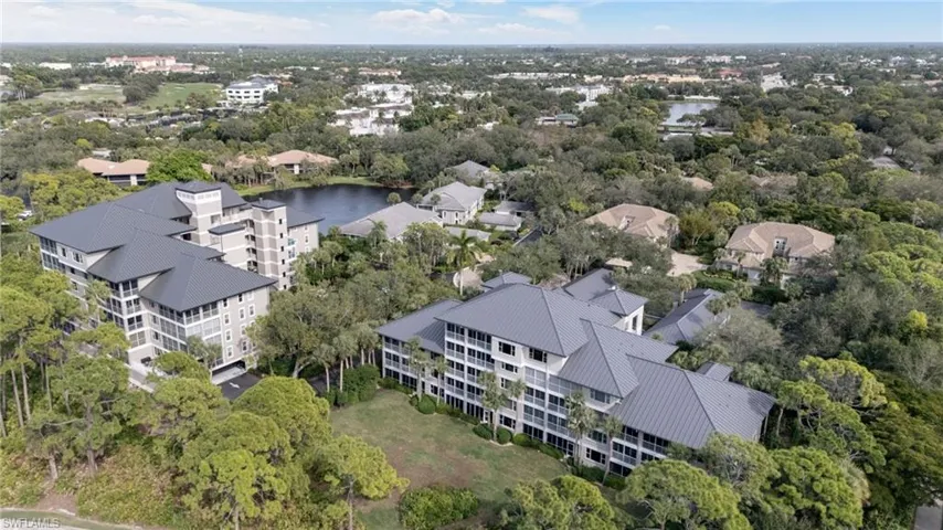 Drone / aerial view of a large body of water and apartment complex