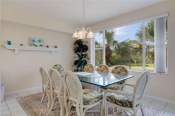 Dining room featuring light tile patterned floors and a chandelier