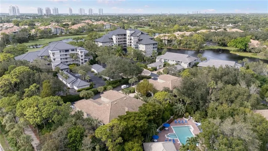 Aerial view of property's location featuring a large body of water and city skyline