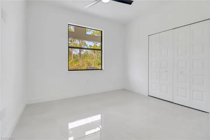 Guest bedroom with a closet and ceiling fan