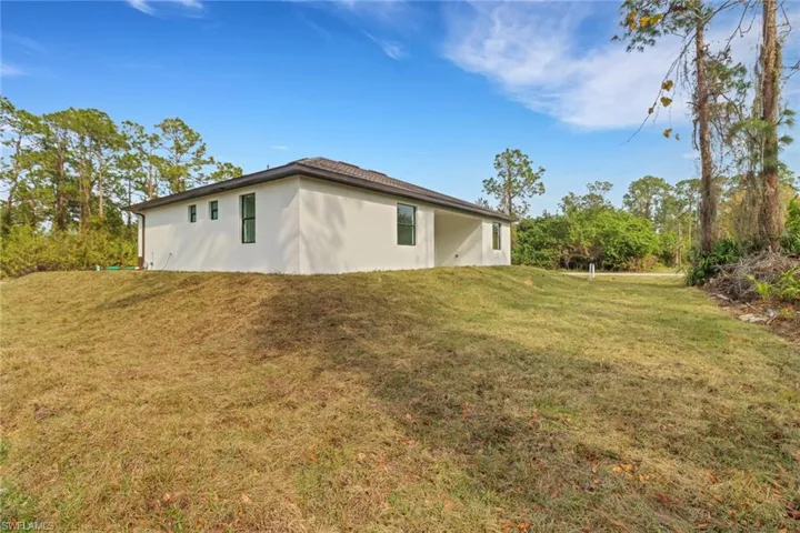 View of property exterior with a lawn