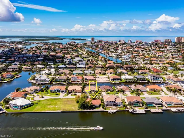 Birds eye view of property with a water view