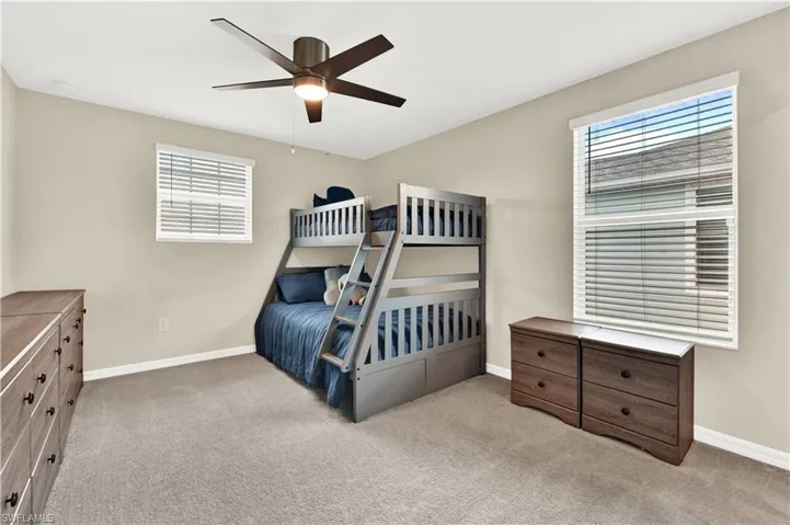 Carpeted bedroom with ceiling fan