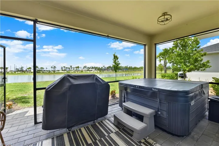 Sunroom with a healthy amount of sunlight and a water view