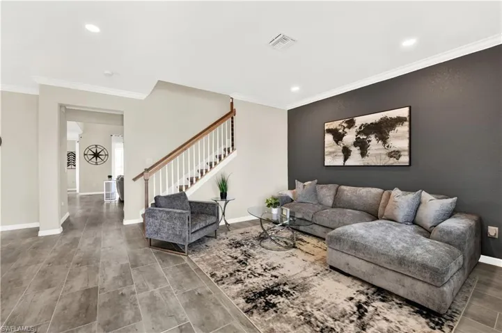 Living room featuring ornamental molding and hardwood / wood-style flooring