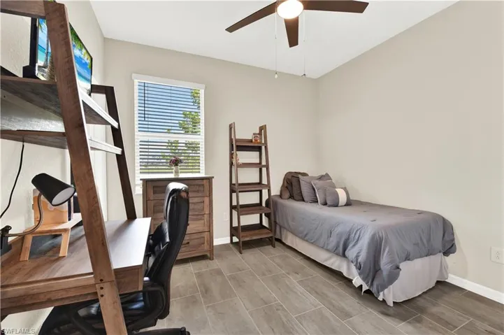 Bedroom with ceiling fan and hardwood / wood-style flooring