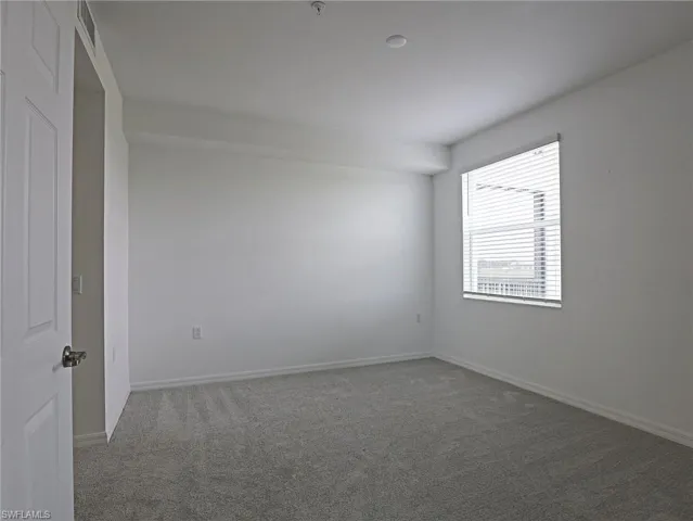 Unfurnished room featuring carpet