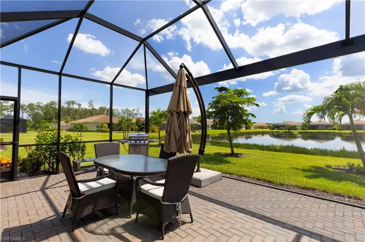 View of patio / terrace with glass enclosure and a water view