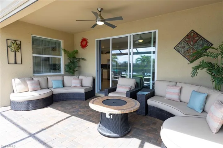 View of patio featuring ceiling fan and an outdoor living space