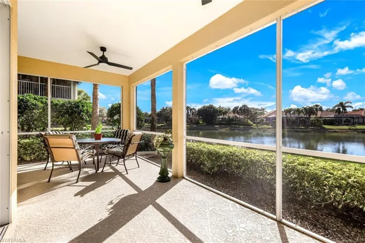 Sunroom / solarium featuring outdoor dining space, a ceiling fan, and a water view