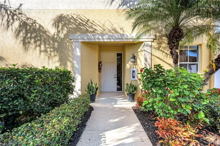 Entrance to property with stucco siding