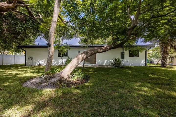 Rear view of property with stucco siding