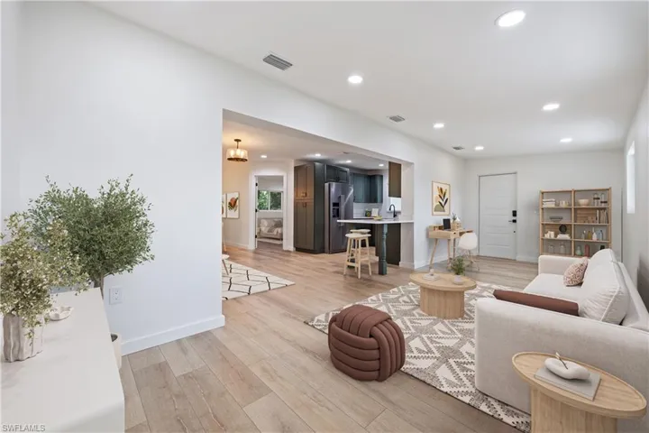 Living area featuring light wood-style floors and recessed lighting