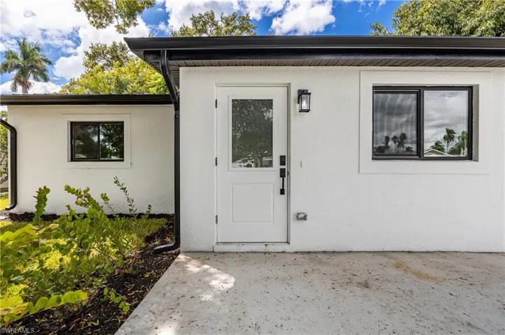 Property entrance featuring stucco siding
