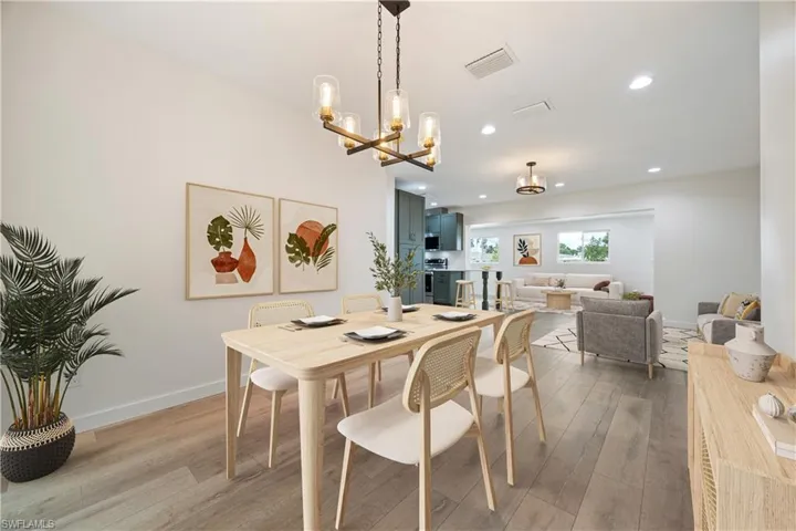 Dining room featuring wood finished floors, recessed lighting, and a chandelier