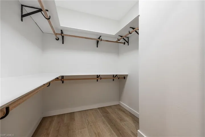 Spacious closet with light wood finished floors