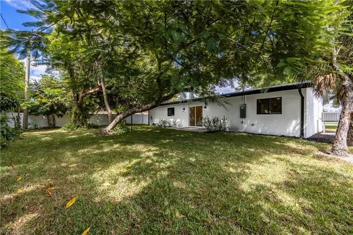 Rear view of house with stucco siding