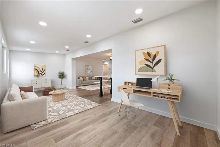 Living area with an office area, recessed lighting, and light wood-style floors