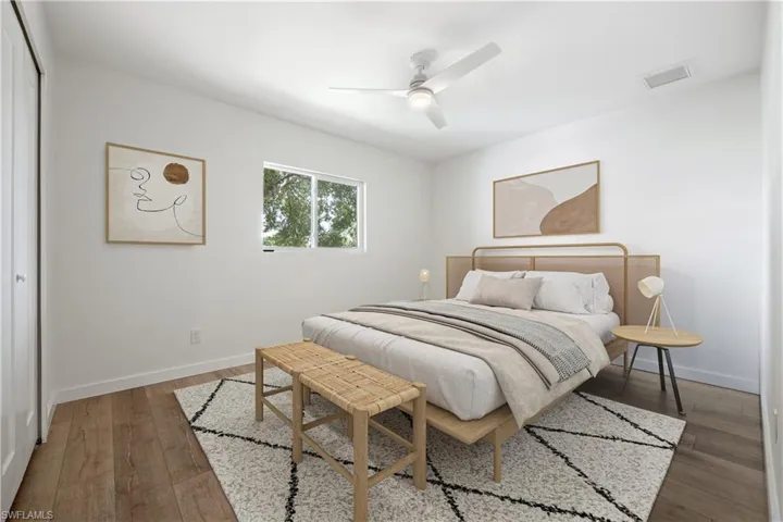 Bedroom featuring a ceiling fan, light wood-style floors, and a closet