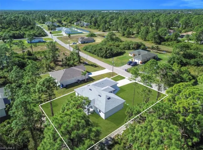 Aerial view of property and surrounding area featuring property parcel outlined