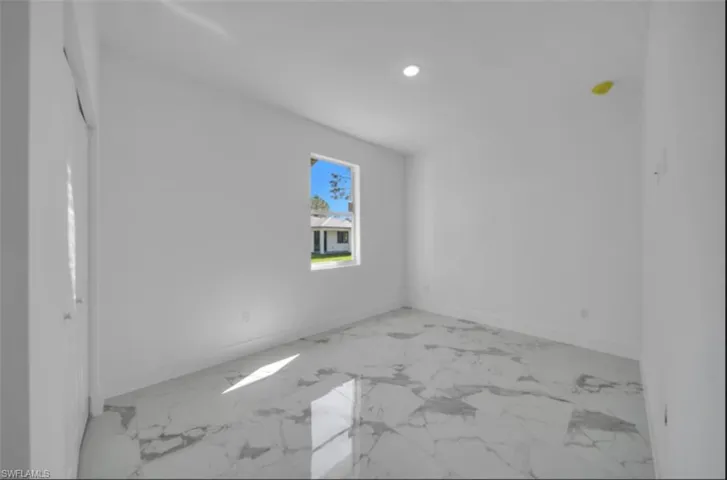 Unfurnished room featuring light marble finish flooring and recessed lighting