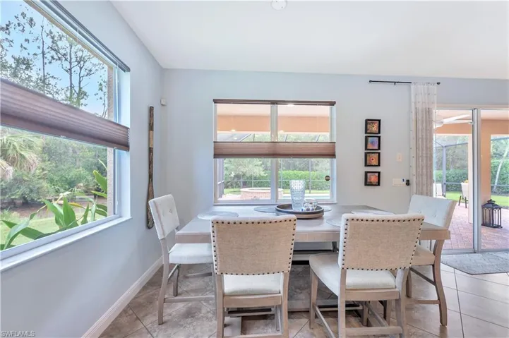 Dining space with plenty of natural light and light tile patterned flooring