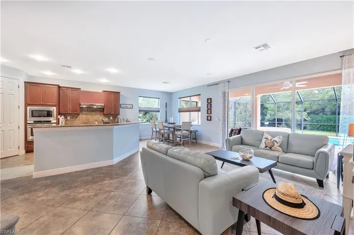 Living room featuring light tile patterned floors and ceiling fan