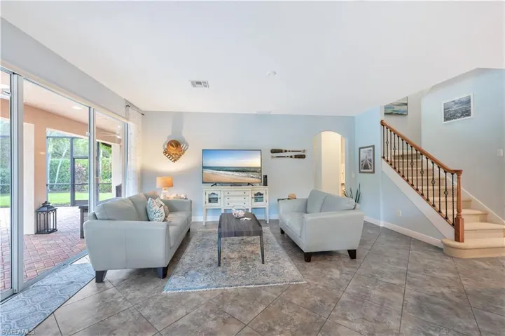 Living area with arched walkways and stairway