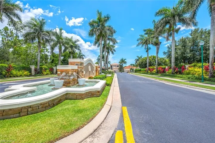 View of asphalt road with curbs, street lighting, and sidewalks