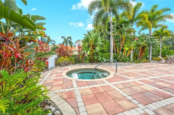 View of swimming pool featuring an in-ground hot tub