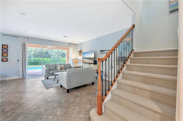Living room with stairs and recessed lighting