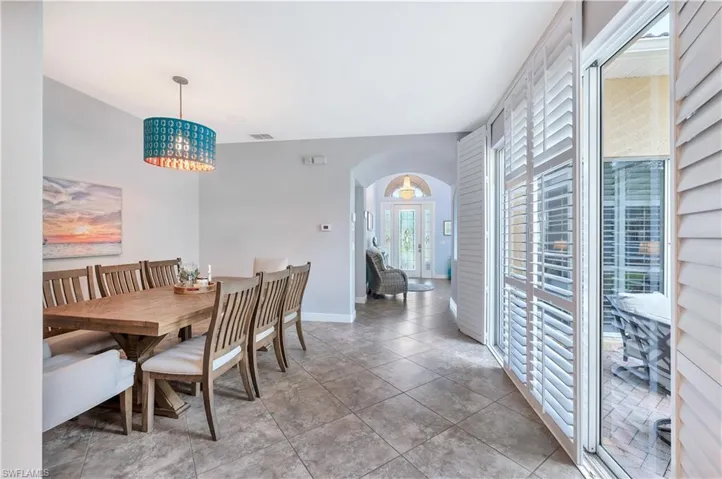 Dining room featuring arched walkways and baseboards