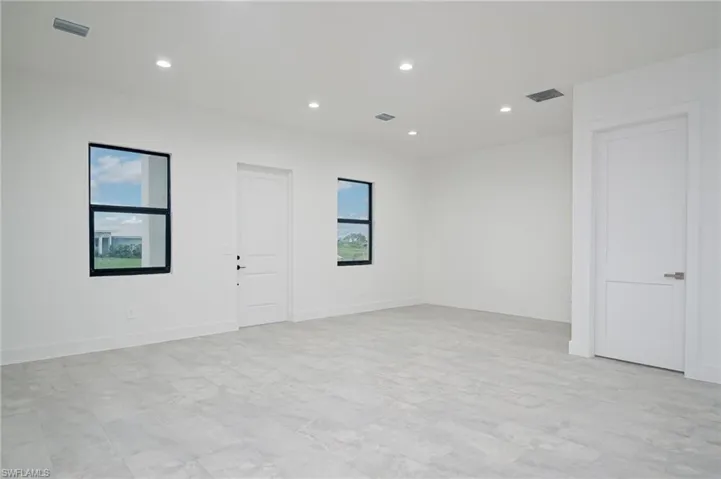 Spare room with light tile flooring