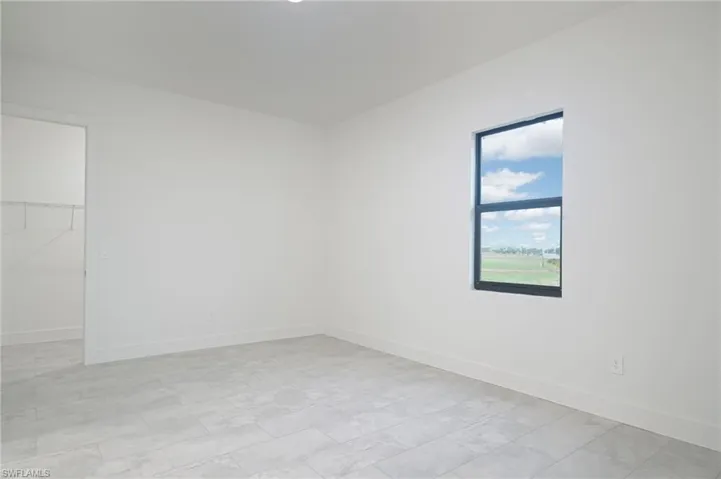 Empty room with light tile floors