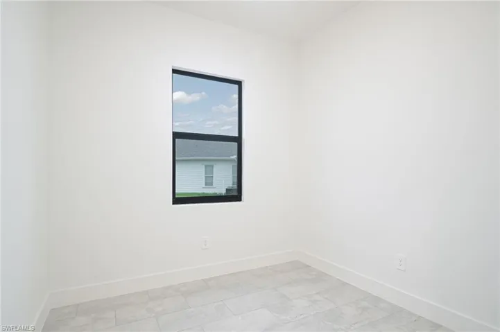 Empty room featuring light tile floors