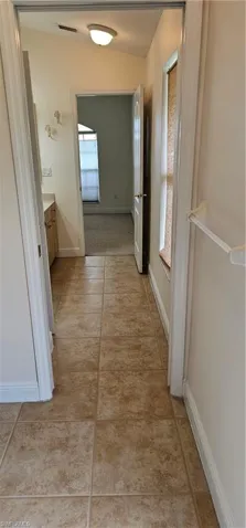 Hallway with tile patterned flooring