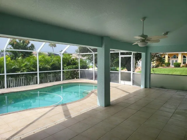 View of swimming pool with a patio area and ceiling fan