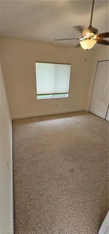 Unfurnished room with carpet flooring and ceiling fan