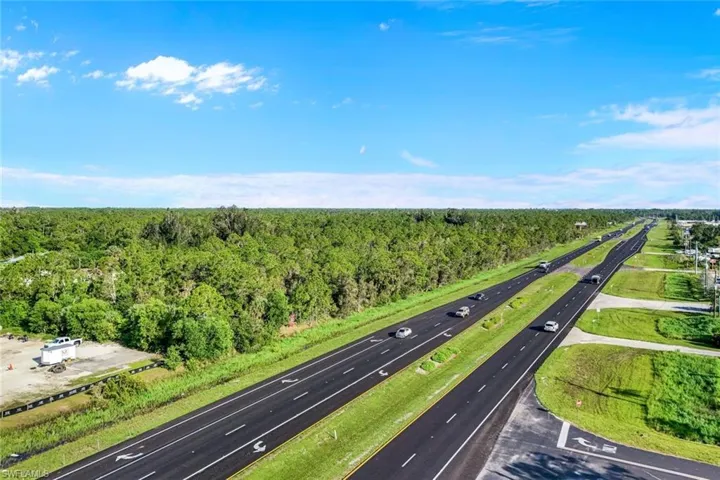 Drone / aerial view of a highway and a heavily wooded area