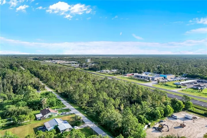 Aerial view of property's location featuring a forest