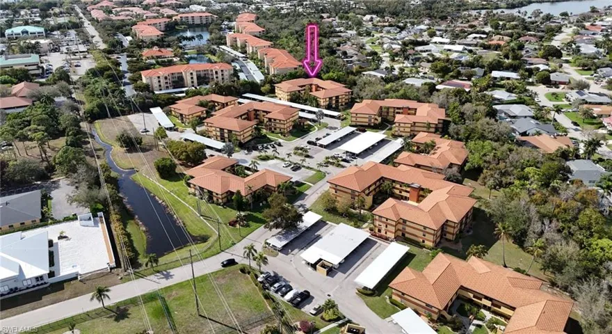 Aerial view of property and surrounding area featuring nearby suburban area